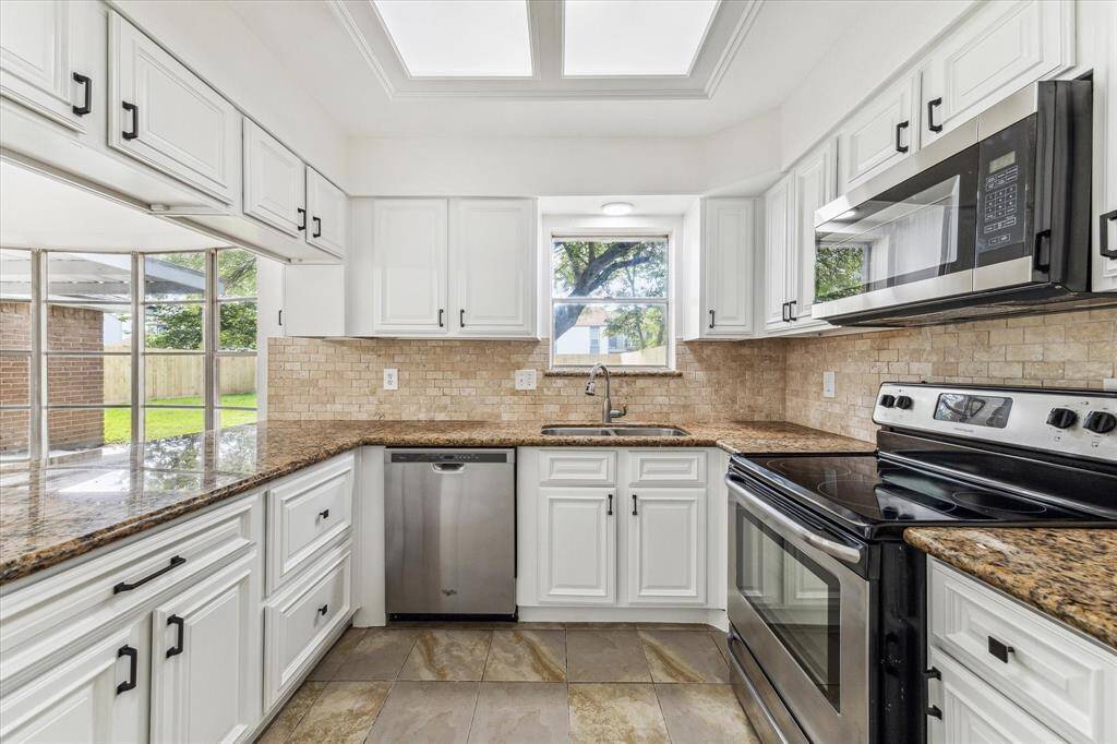 UPDATED STAINLESS STEEL APPLIANCES BRING MODERN CONVENIENCE TO THIS CLASSIC KITCHEN.