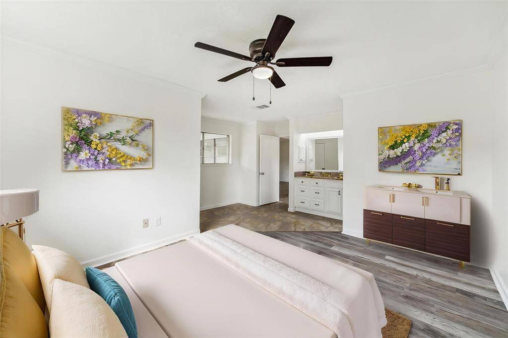 SPACIOUS PRIMARY BEDROOM FEATURING NEW LUXURY VINYL PLANK FLOORING, FRESH PAINT, AND UPDATED FIXTURES FOR A MODERN TOUCH. **This photo has been virtually staged.