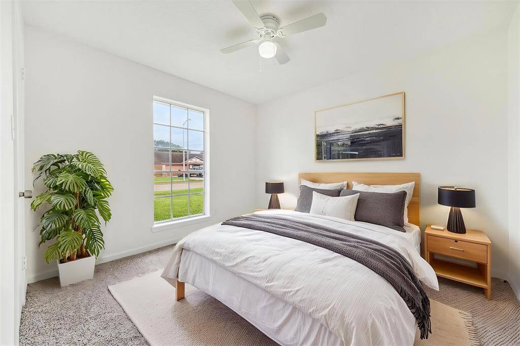 LIGHT-FILLED BEDROOM WITH NEW CARPETING AND A LARGE WINDOW OVERLOOKING THE FRONT YARD. **This has been virtually staged.