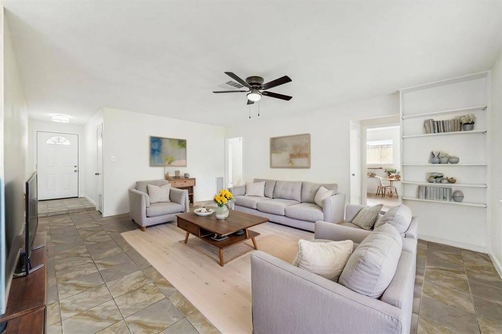 EXPANSIVE FAMILY ROOM WITH NEW CEILING FAN AND MODERN LIGHT FIXTURES. **This has been virtually staged.