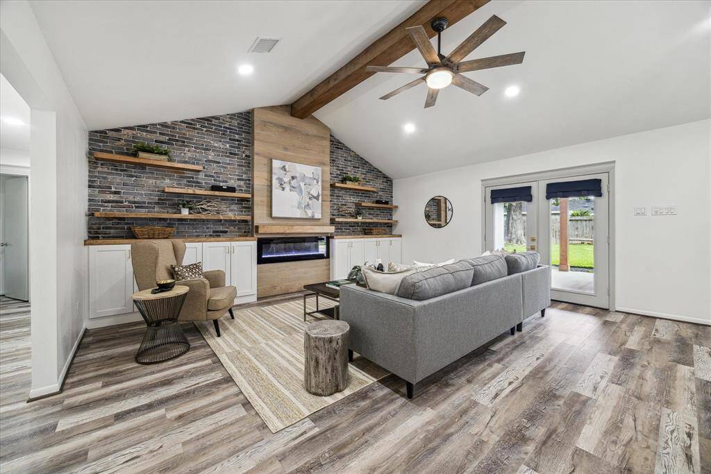 The living room opens onto the covered porch through French doors.