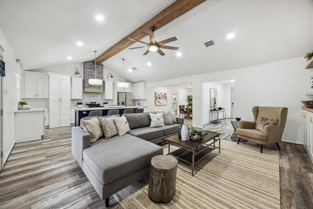 A view of the living room, kitchen, dining room and foyer.