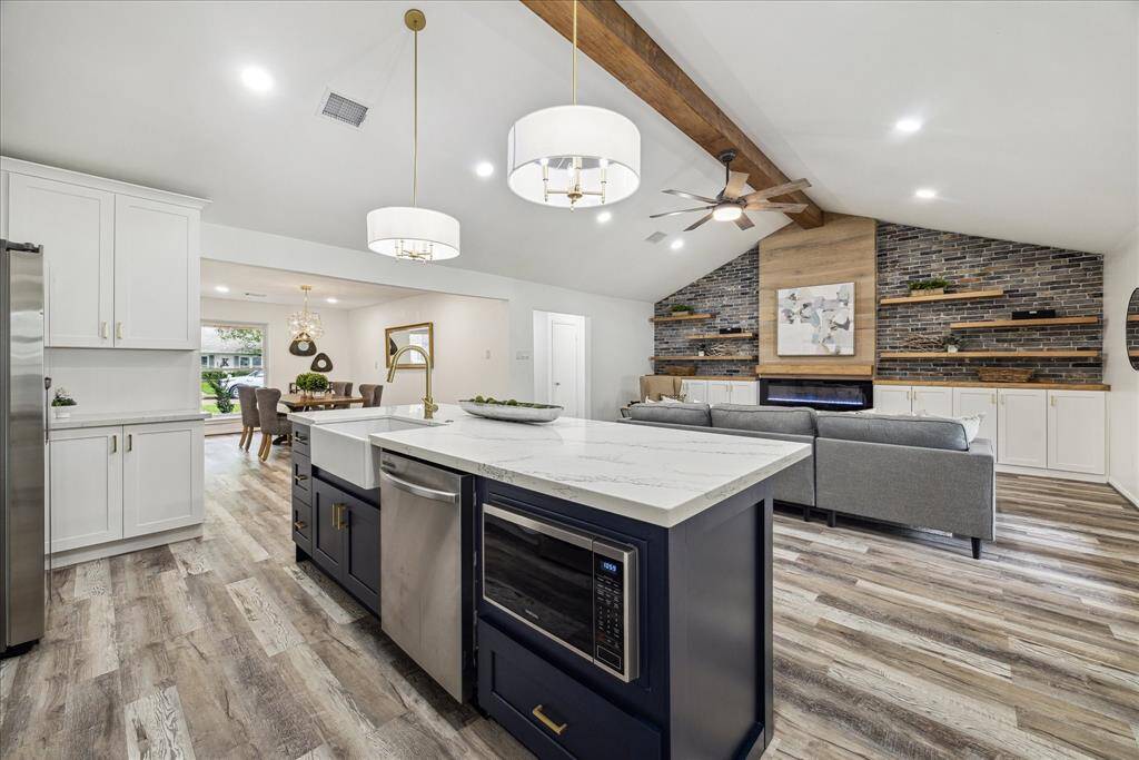The island features a charming farmhouse sink and a convenient built-in microwave