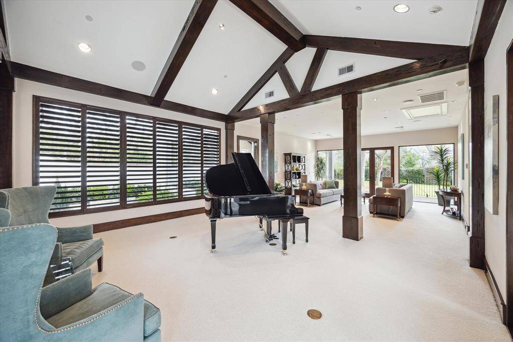 Note the vaulted ceilings, shutters, smart lighting system and wood beams.