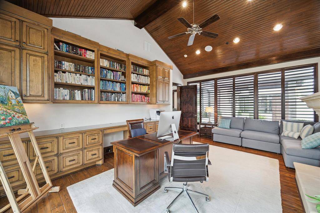 The study features a wall of built-in's, huge windows to the yard and to the courtyard, pine floors...