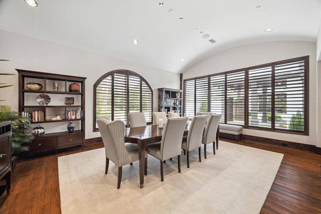 Dining room also has wall of windows, arched windows, pine floors...