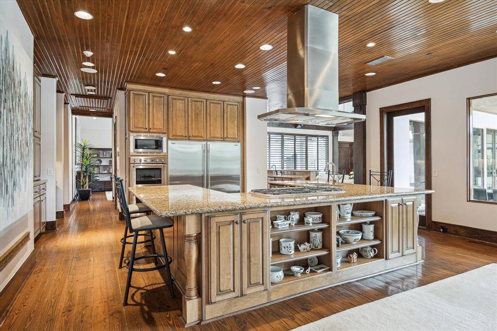 Open kitchen to the Family/Breakfast room... Stainless steel appliances include double Thermador ovens, Thermador gas cooktop and Subzero full sized side by side refrigrator/freezer.