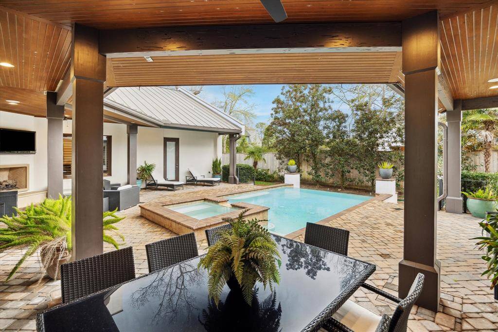 Outdoor area is complete with mosquito system, outdoor fireplace, entertaining spaces, outdoor kitchen and pool & spa.