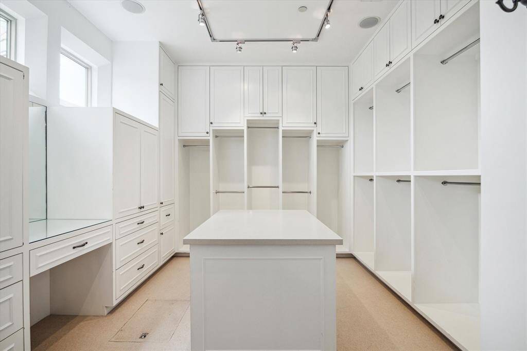 1 of 2 primary closets with bespoke closet systems.