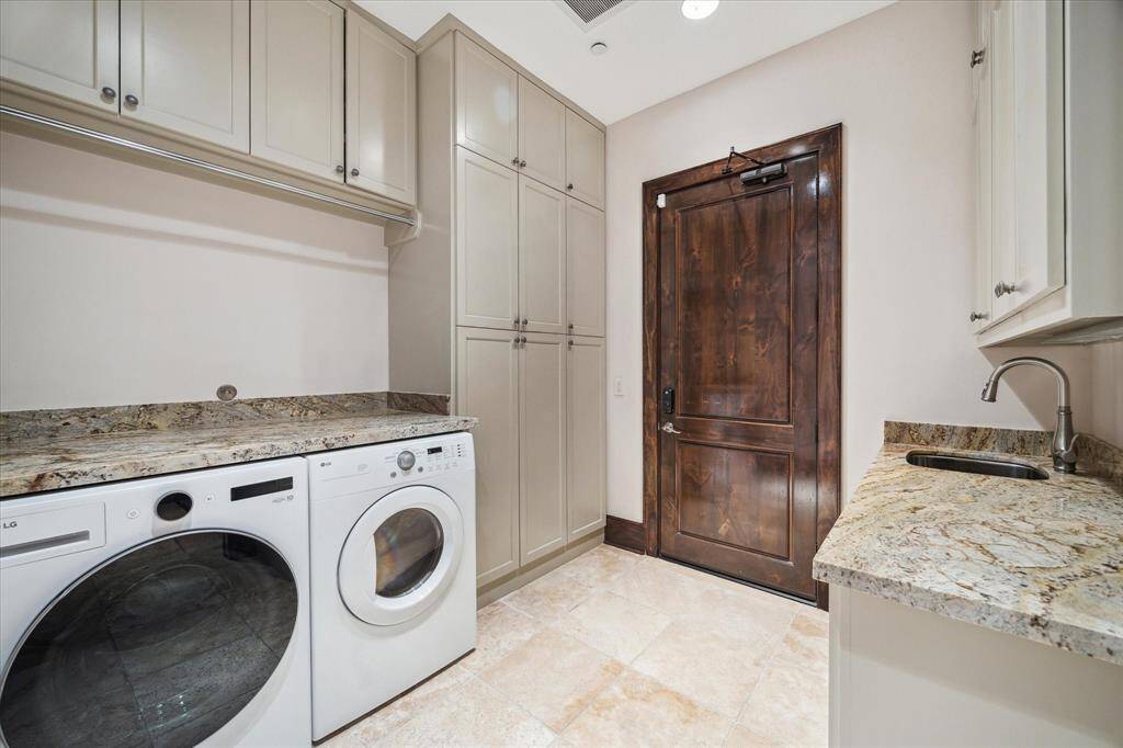 Well-appointed laundry room with sink, tons of storage.