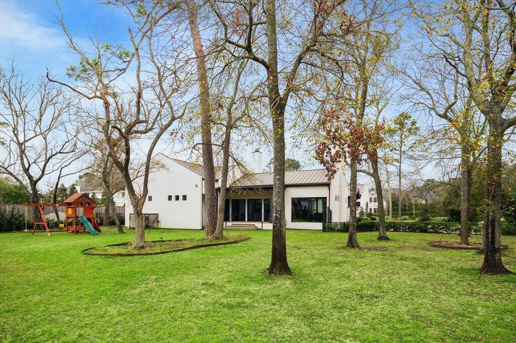 Huge yard space with mature trees, outdoor lighting & lush landscapes.