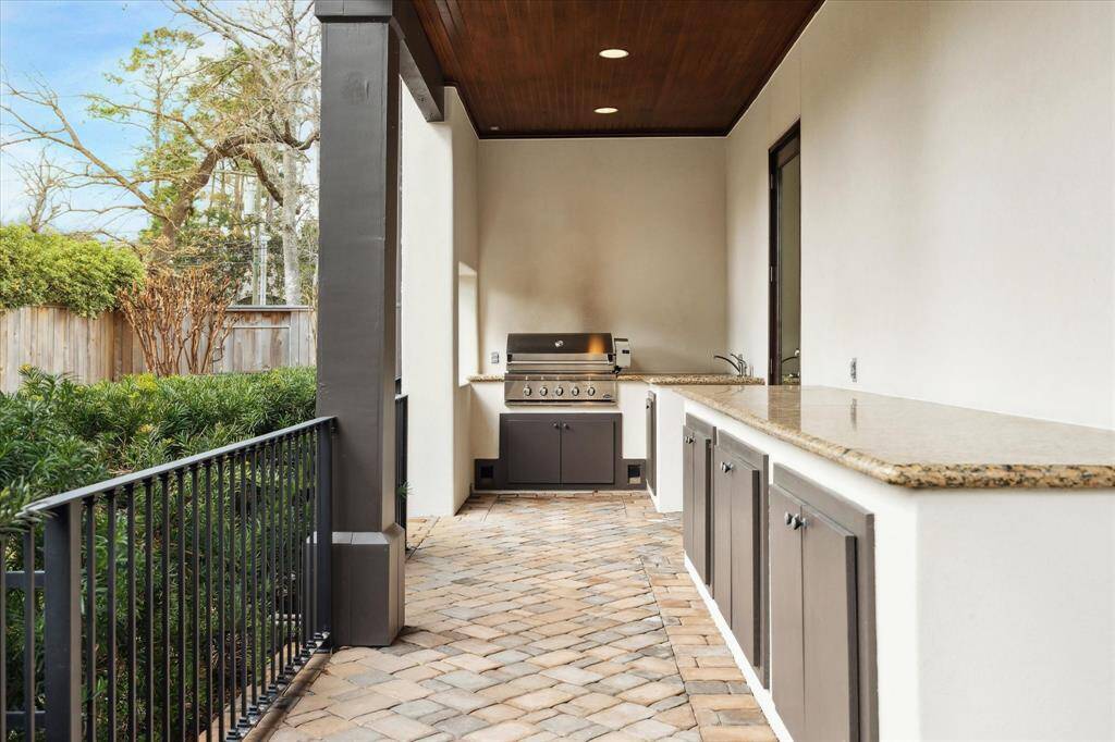 Outdoor kitchen with gas grill, sink, granite counters and tremendous storage.