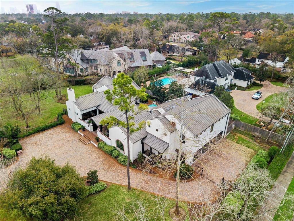 Aerial view shows the standing seam metal roof, tons of parking for entertaining, huge yard...