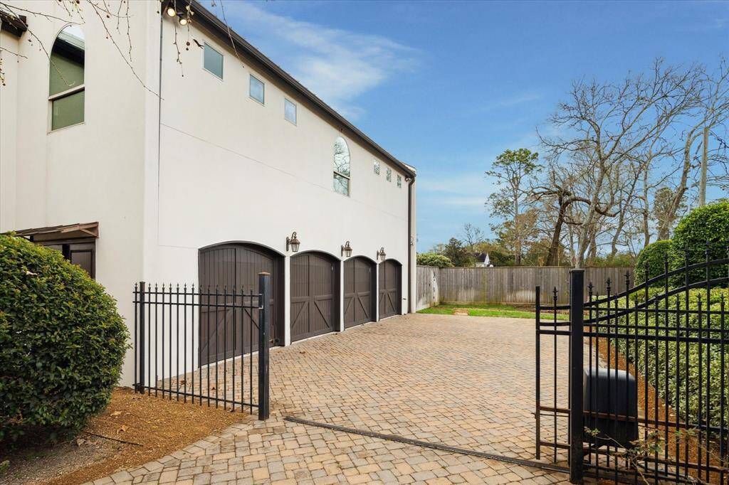 Full 4-car garage with individual doors, motor court, ample parking...