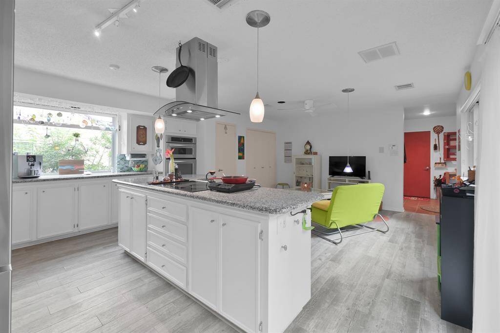 Kitchen overlooks seating area currently used as a keeping room to keep family and friends close as you prepare a meal.  This space can also be a breakfast room.