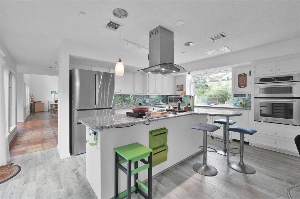 This nicely updated kitchen offers stainless appliances, granite countertops, under counter lighting,  double oven.