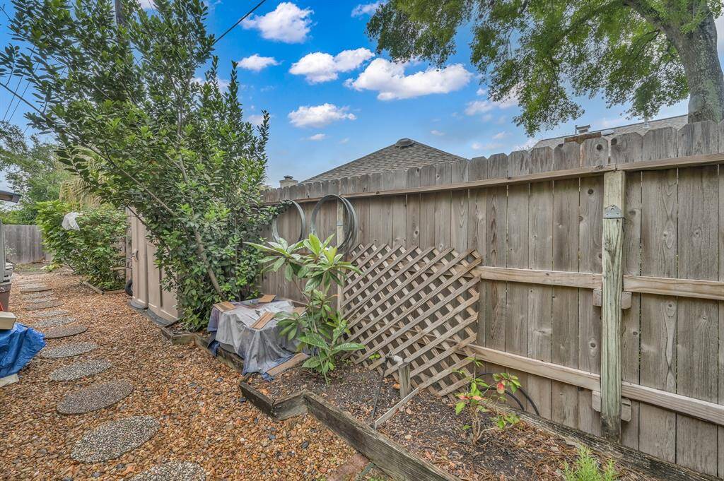 This well thought out space provdes storage for some of your outdoor items and tools. Also home to berry bushes, fruit trees and graveled path.