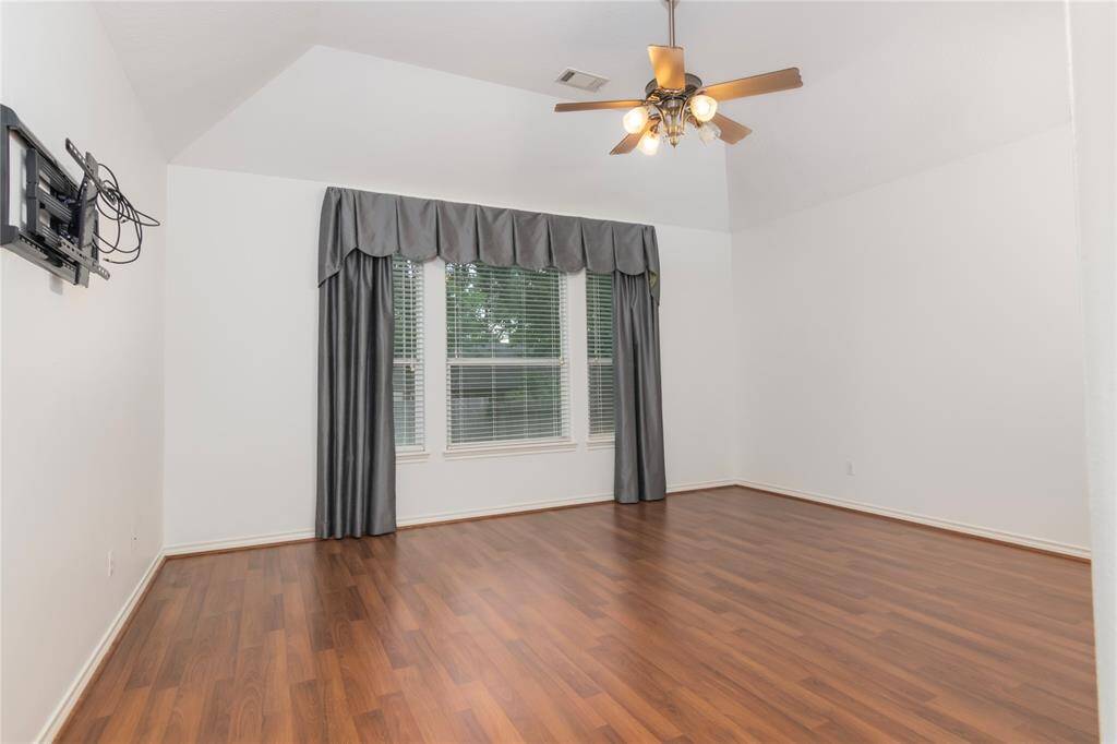 Large master bedroom with high ceilings.