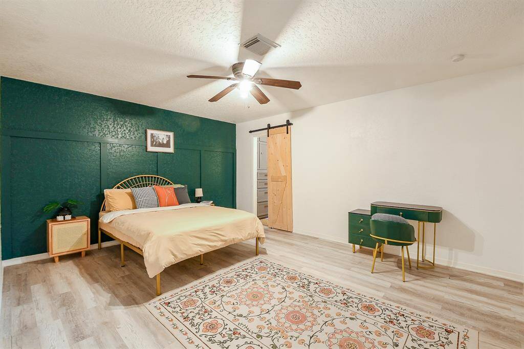 Primary bedroom with ensuite and large window to back yard