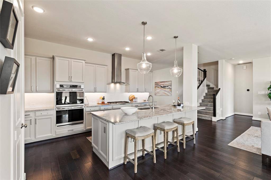 Gourmet Kitchen"Double ovens, granite island, and abundant cabinets open to living and breakfast nook."