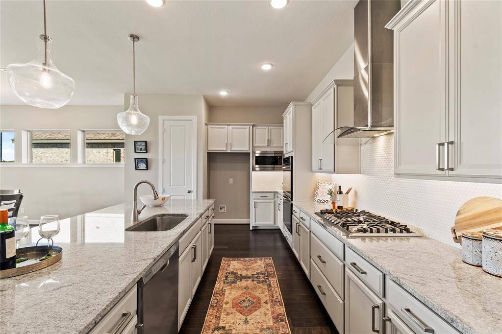 Modern chefs' kitchen with granite countertops  and stainless steel appliances