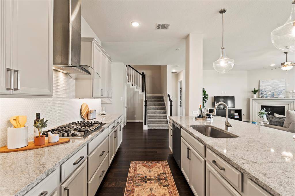 Kitchen from another angle plenty of cabinet space and open flow to living room and stairs