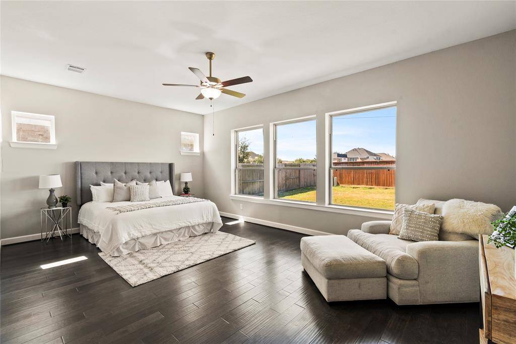 Primary room suite with energy-efficient windows, jacuzzi tub, and two walk-in closets."