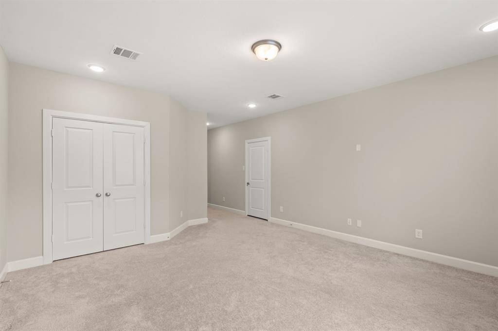 "Roomy bedroom with ample storage and natural light."