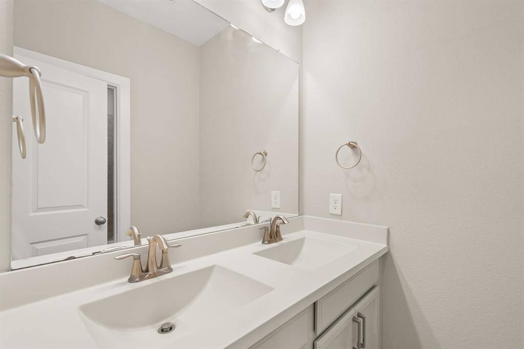 "Elegant full bathrooms with modern fixtures and plenty of space."