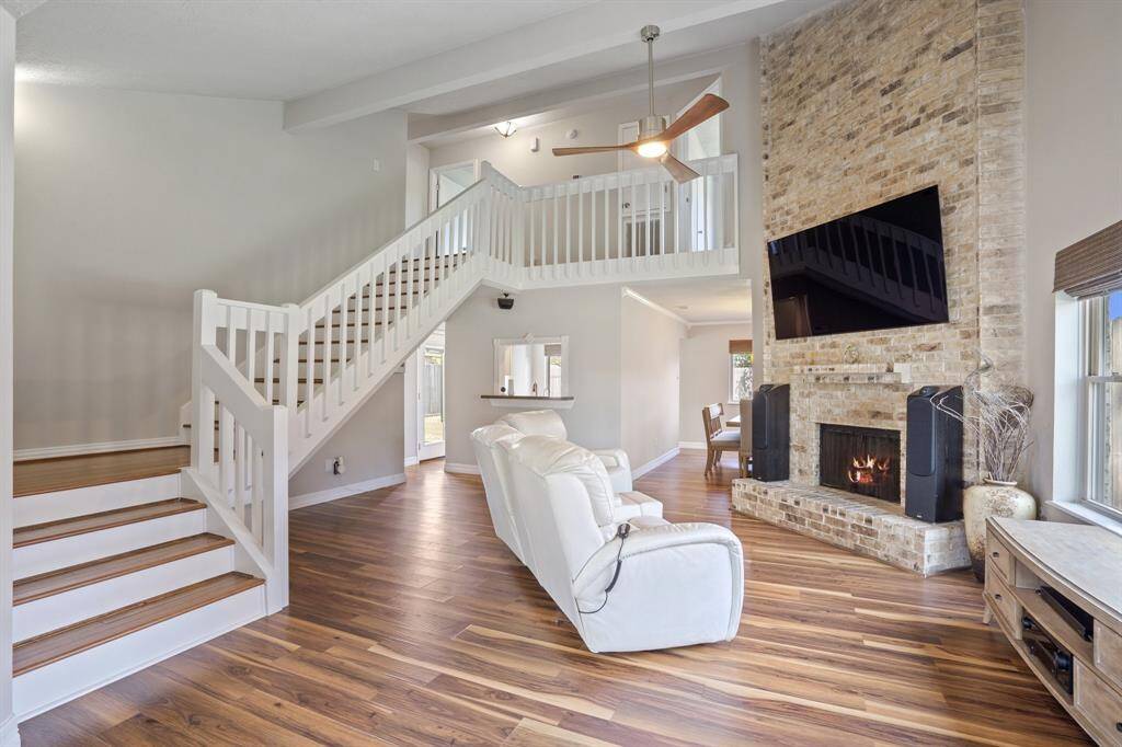 Big and bright family room complete with a cozy fireplace, hearth and mantle.