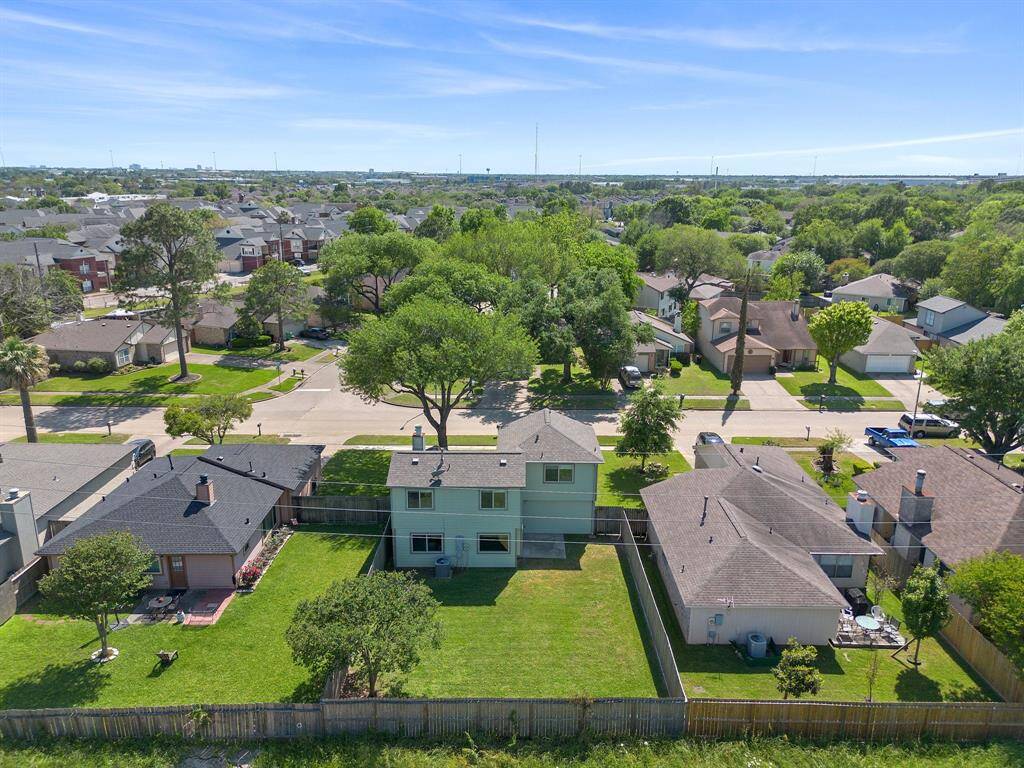 Ariel view of the back of the home. Notice the mature trees throughout the neighborhood.