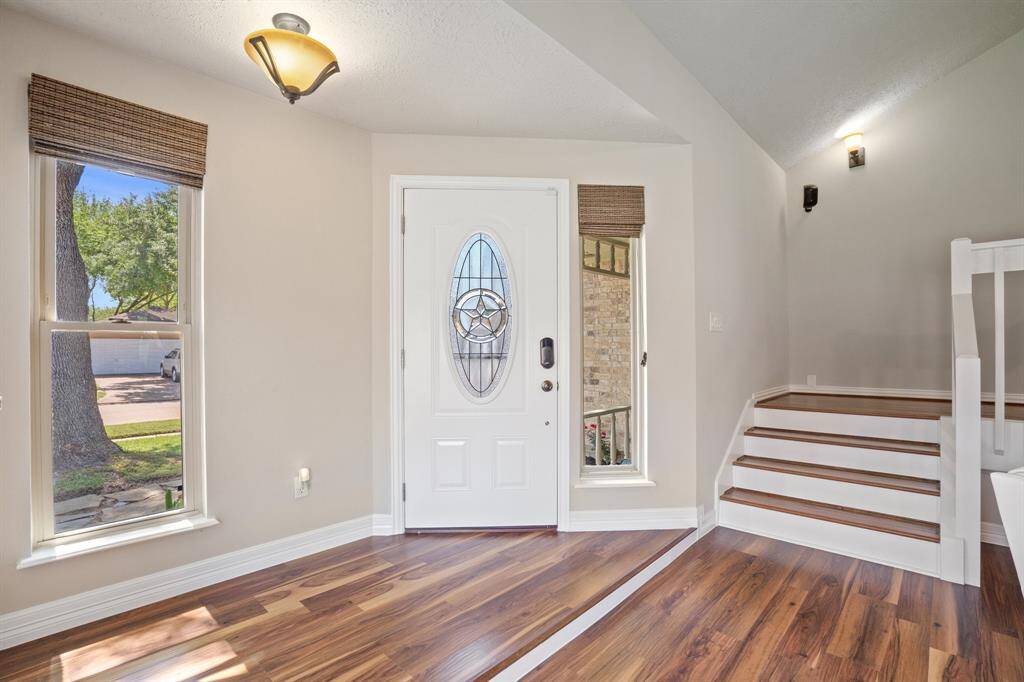 Following the flow of the home, the entryway leads you into the family room.  Beautiful flooring throughout the home.