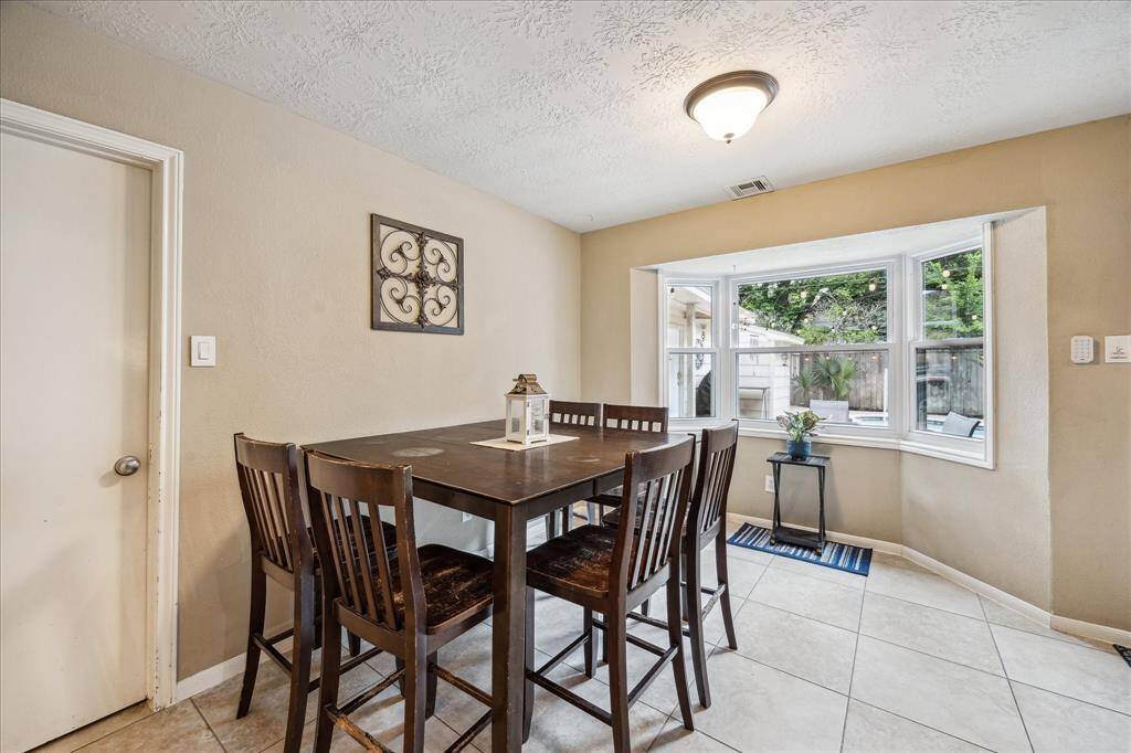 Generous breakfast room is located right off of the kitchen and is open to the living area. Sit here and sip your coffee while you gaze out towards the sparkling pool.