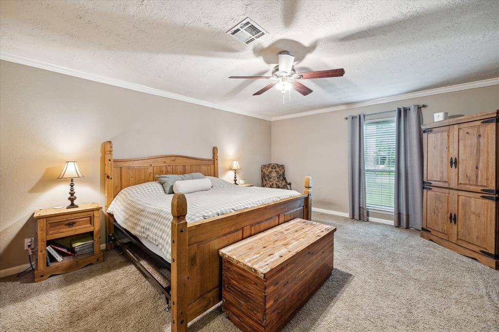This primary bedroom has enough room for a California King sized bed and then some!