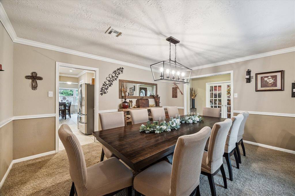 Spacious formal dining room seats 10 comfortably, with additional space for a buffet.