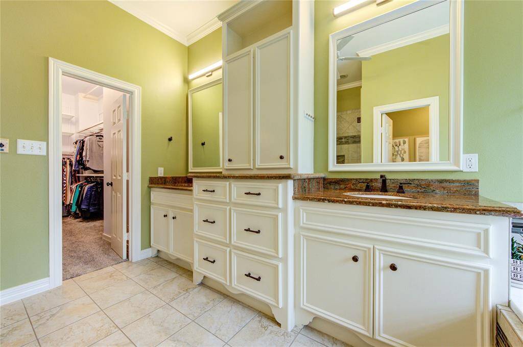The his-and-her sinks are separated for maximum privacy and space, offering plenty of room for personal grooming.