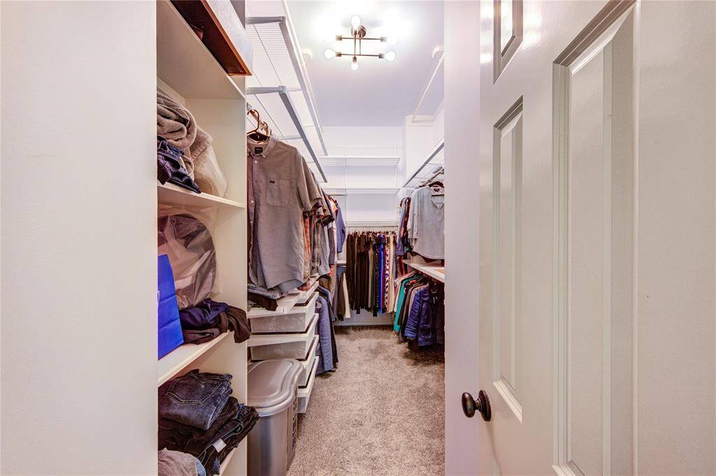 The oversized walk-in closet includes built-in shelves, drawers, and generous hanging space—perfectly designed for organization and convenience.