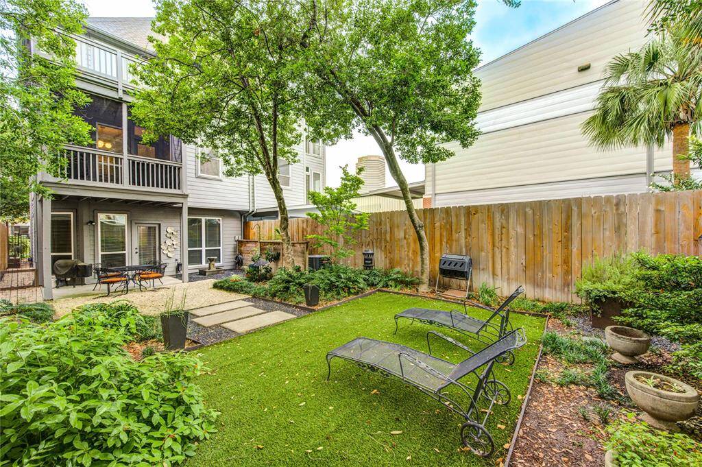 Step into one of the largest private backyards you'll find in a townhome—an exceptionally rare feature in this area. This expansive, fully fenced outdoor space is designed for both beauty and function, featuring high-end AstroTurf for year-round greenery with zero maintenance.