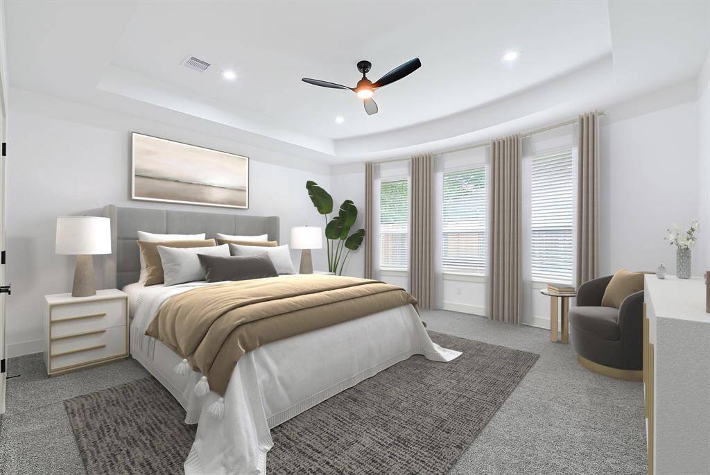 Spacious primary bedroom with abundant natural light and direct access to a luxurious en-suite bath. (photo is virtaully staged)