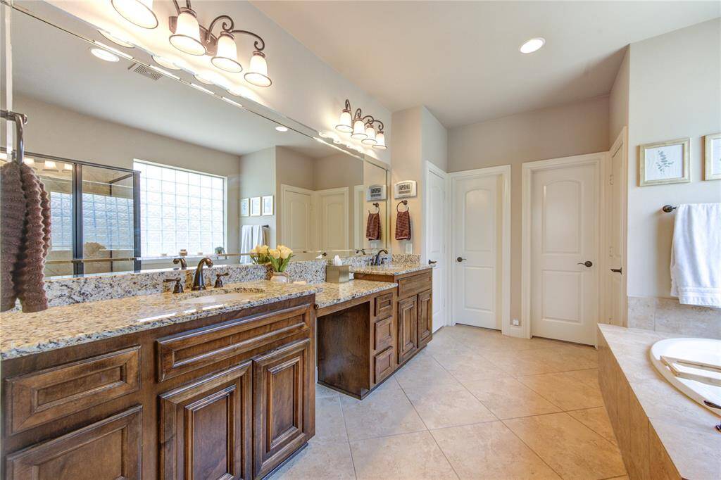 Rest and relax in the Downstairs primary bathroom offers natural light + separate tub & shower + 2 large primary closets + 2 sinks with a vanity and a private water closet