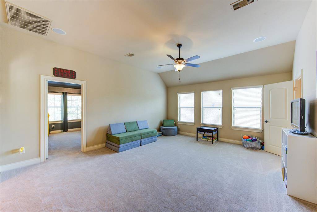 Massive upstairs game room offers a 1/2 bathroom + game closet. 19 feet by 16 feet.