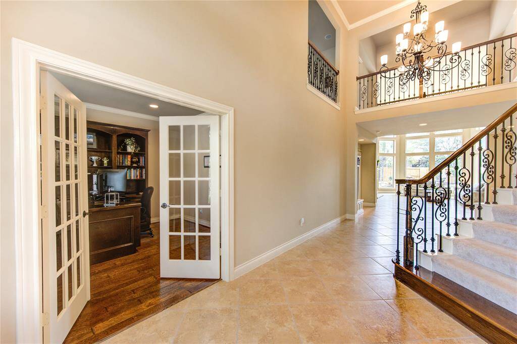 Private office space with a custom built-in wood desk with crown molding and natural light on beautiful wood floors. 13 feet by 11 feet