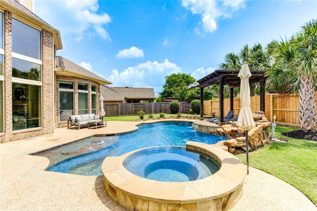 The next BridgelandFamily will enjoy the hot-tub and swimming in the custom family pool and cooking on the summer kitchen under the massive covered patio