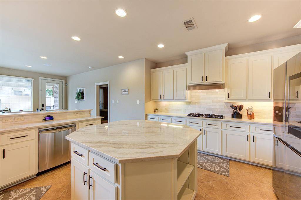 Beautifully appointed and updated kitchen with 55 soft close cabinets and drawers + a separate coffee bar and walk-in pantry