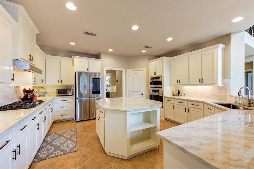 Under cabinet lighting with offers a luxurious touch with the Incredible updated kitchen space with 55 soft close cabinets and drawers + a separate coffee bar and walk-in pantry