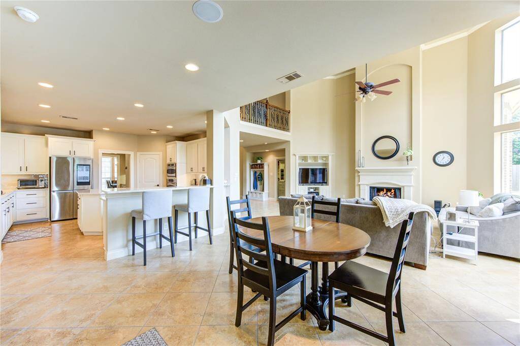 Open concept living space opens to the breakfast area and to the updated kitchen with 55 soft close cabinets and drawers + bar height seating