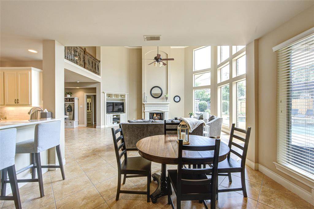Open concept living space opens to the breakfast area and to the updated kitchen with 55 soft close cabinets and drawers + bar height seating