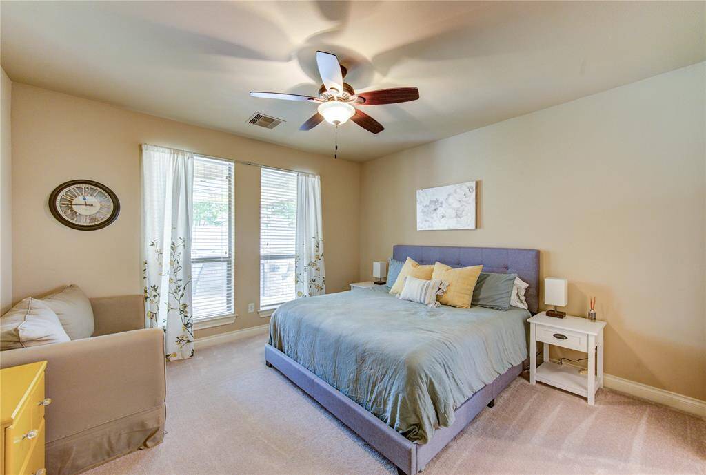 Downstairs Mother-in-law suite with natural light is welcoming for older guests on the opposite side of the home from the primary bedroom. This en-suite guest bedroom is 13 feet by 13 feet