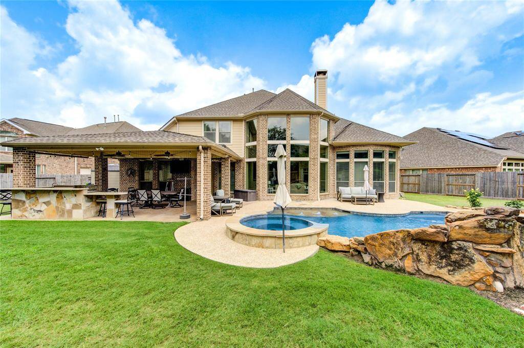 Multiple Green spaces on a lot that is nearly 12,000 sq ft perfect for entertaining with a media room, game room and 4 bedrooms