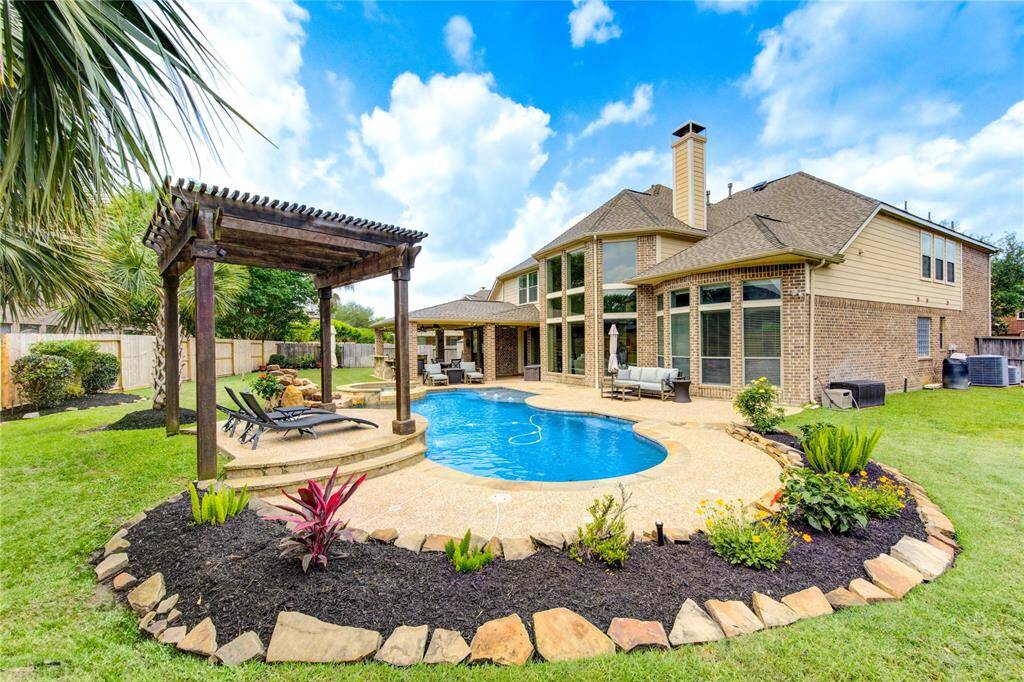 Multiple Green spaces on a lot that is nearly 12,000 sq ft perfect for entertaining with a media room, game room and 4 bedrooms